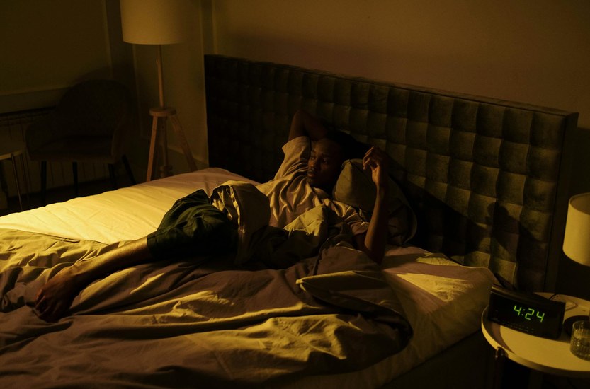 Person liegt wach im Bett bei Schlafproblemen im Cannabis-Entzug